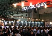 Visitors look at Square Enix Co.'s video game titles display